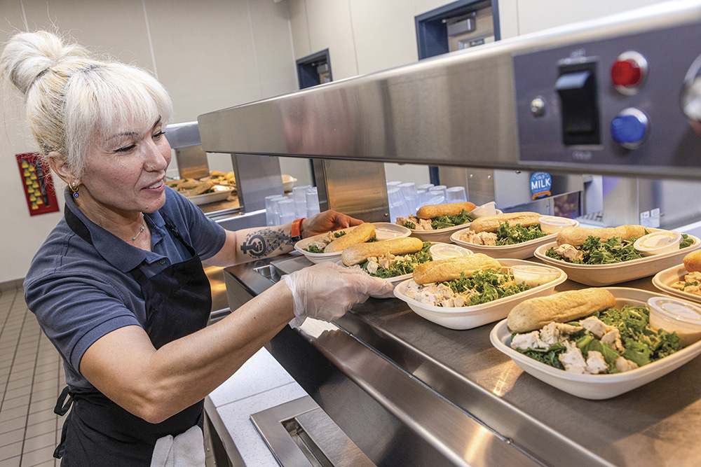 Hatice Roberts serves lunch at Sierra Vista School in Vacaville, which sources produce from California farms.